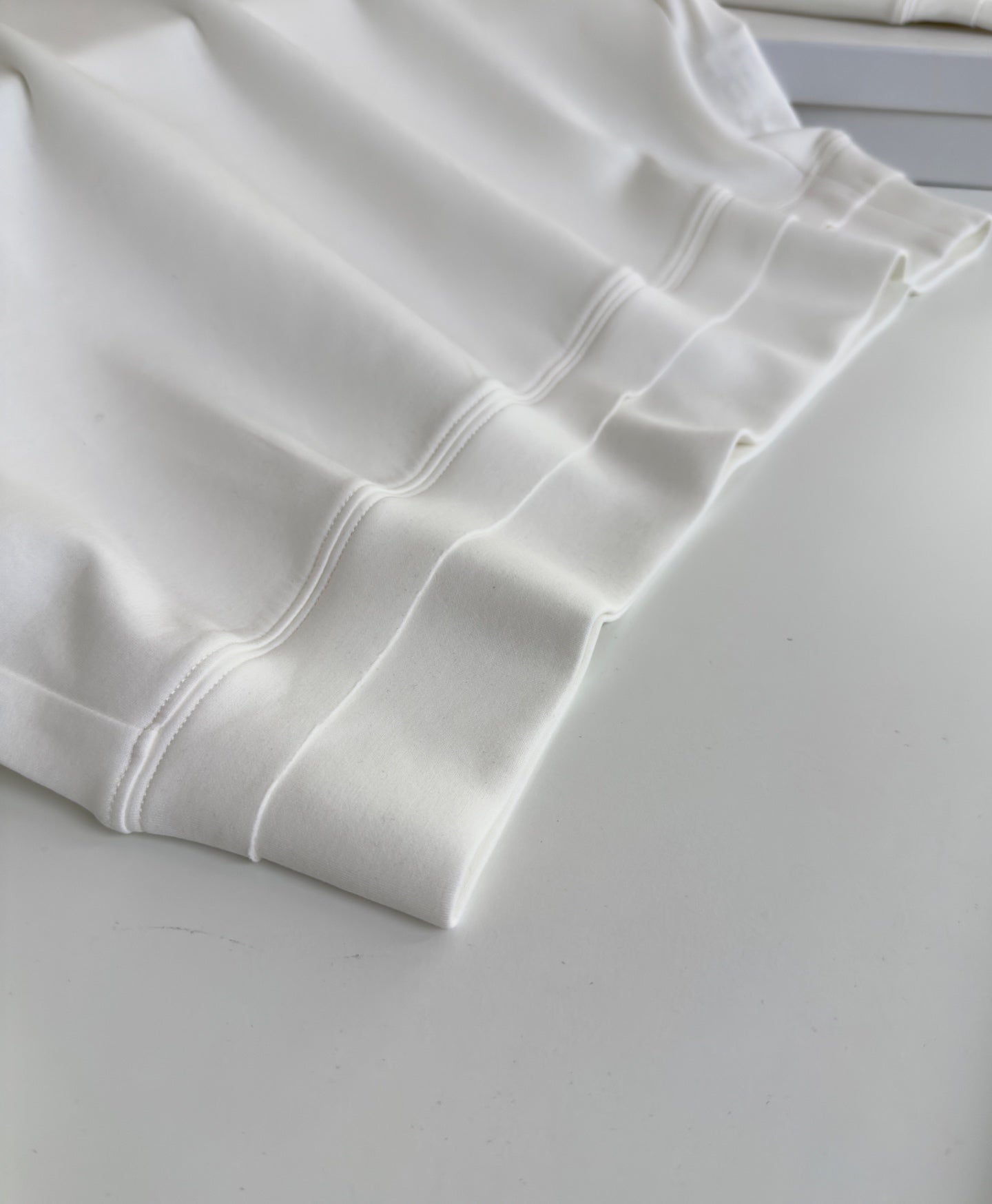 BRUNELLO CUCINELLI MINIMALIST STRUCTURAL GEOMETRIC CUTTING WHITE SWEATSHIRT